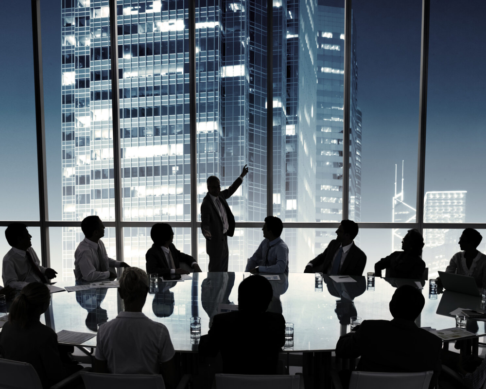 Business people in a board room meeting Business people in a board room meeting