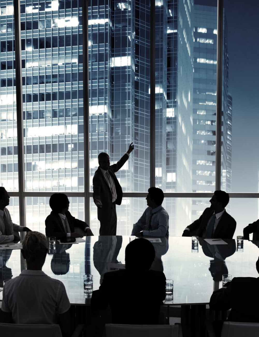 Business people in a board room meeting Business people in a board room meeting